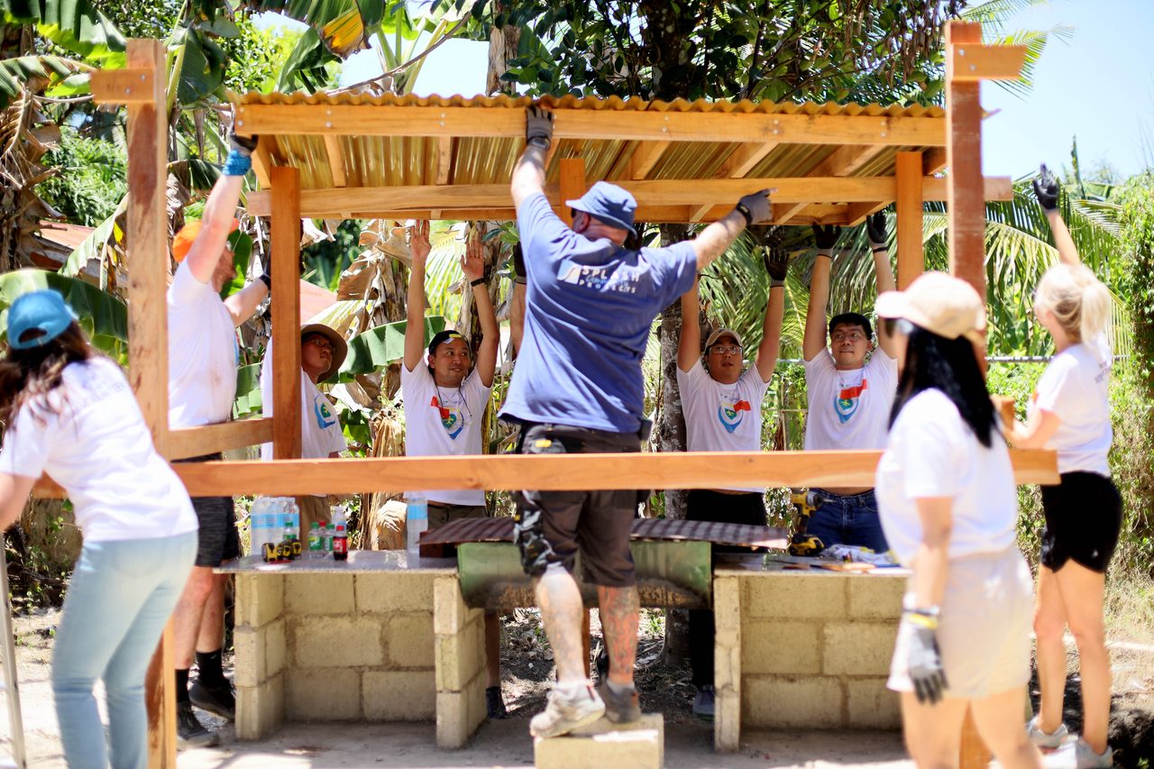 Community partners building together outdoors